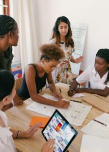 A young and diverse team discusses business planning around a table.
